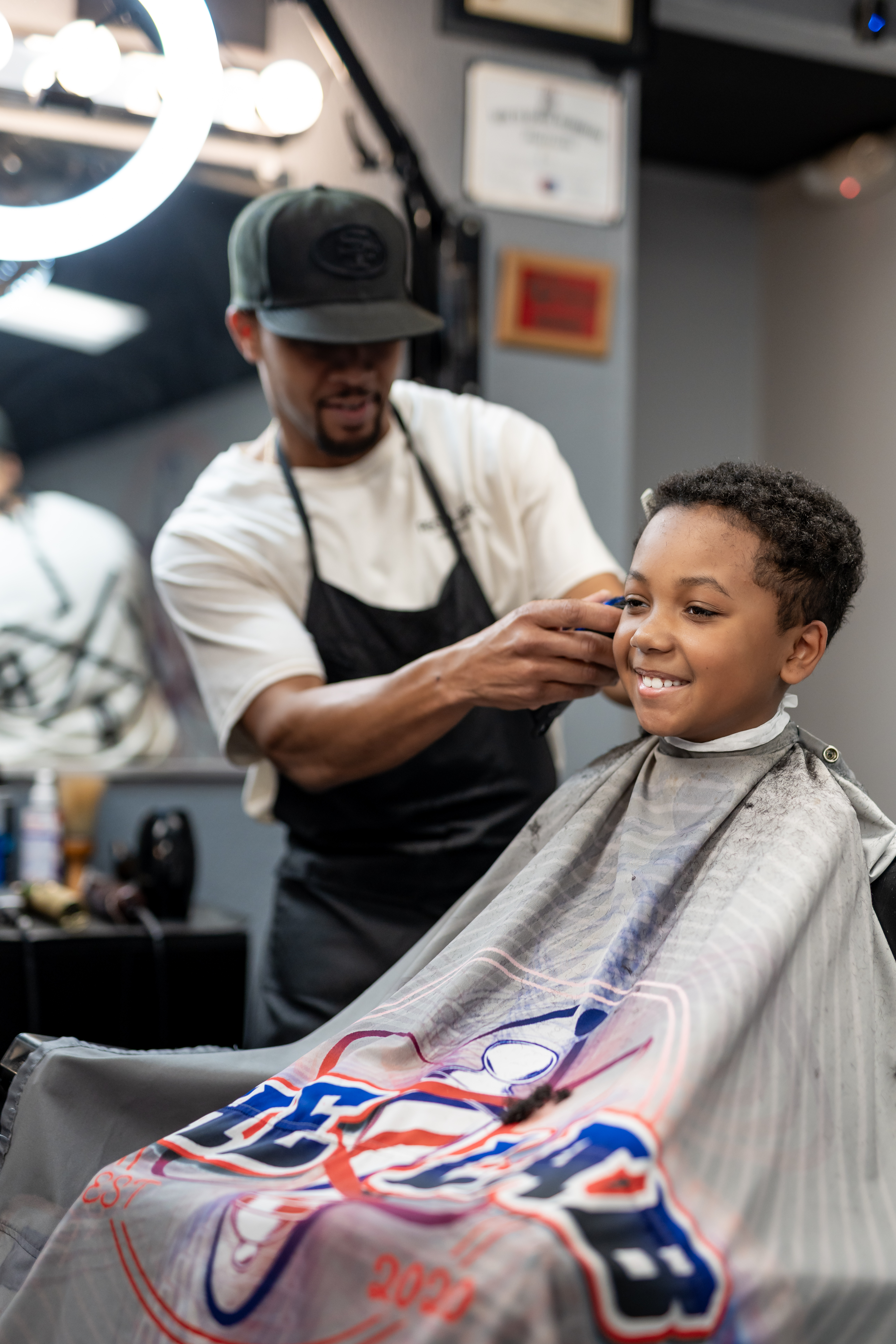 Barber giving a fade to a young client at The Lab Barbershop in Manor Texas